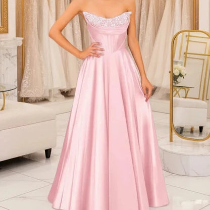 Blush pink strapless beaded satin A-line evening gown with sparkling neckline