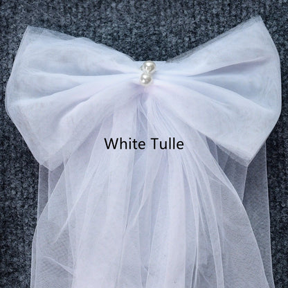 White tulle shoulder bow with gathered fabric and pearl center