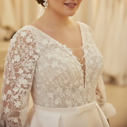 White satin wedding dress with lace bodice, V-neck detail, three-quarter lace sleeves