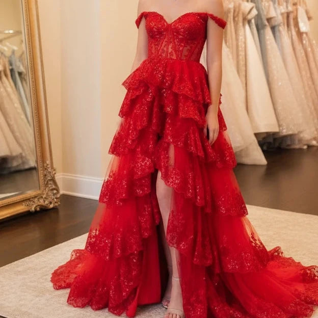 Red lace formal gown with off-shoulder sleeves, sweetheart bodice, and ruffled skirt