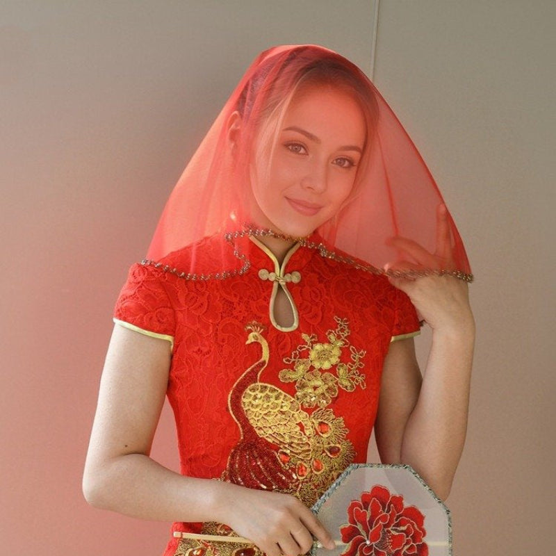 Red short bridal veil head cover with beaded trim, veil framing face and head