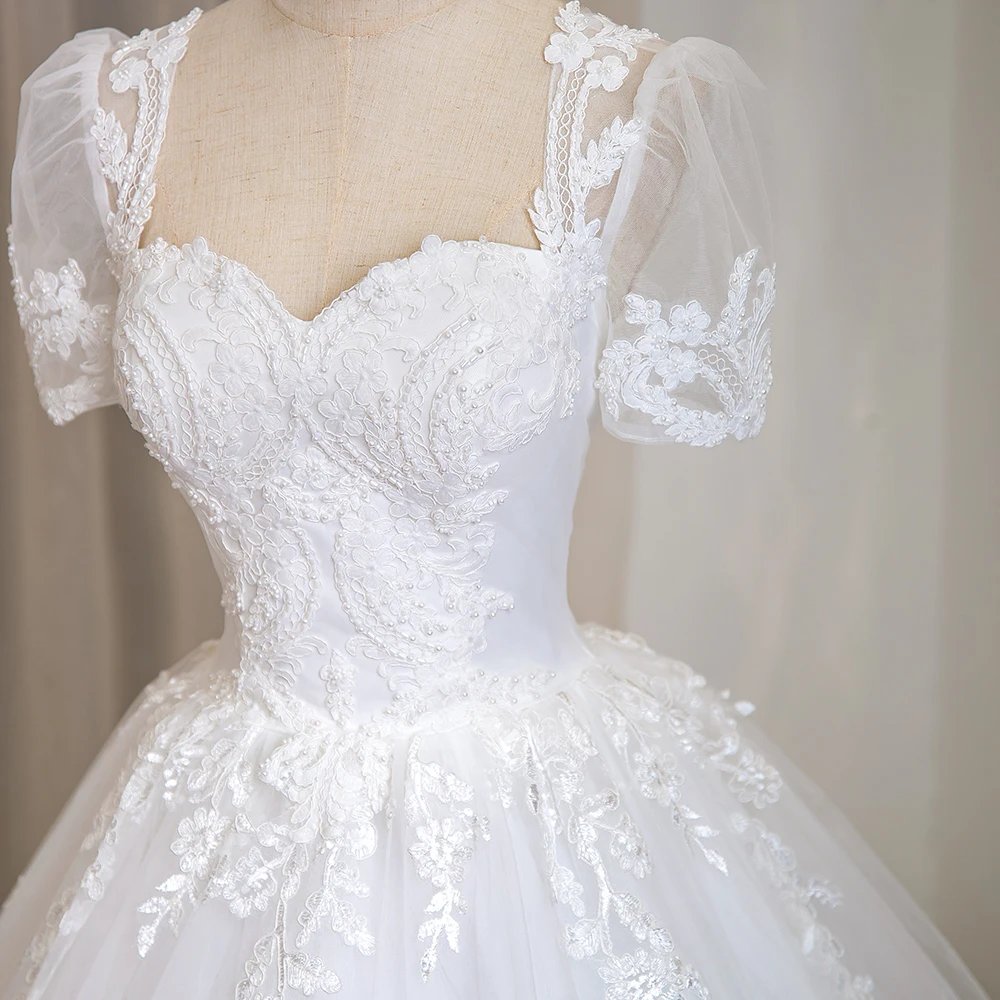 Ivory beaded lace bridal bodice with illusion sweetheart neckline and short puff sleeves
