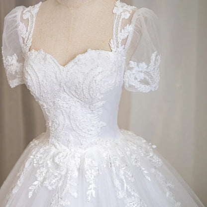 Ivory beaded lace bridal bodice with illusion sweetheart neckline and short puff sleeves