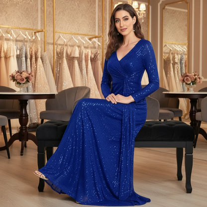 Royal blue sequin maxi dress with long sleeves, V-neck, and draped skirt