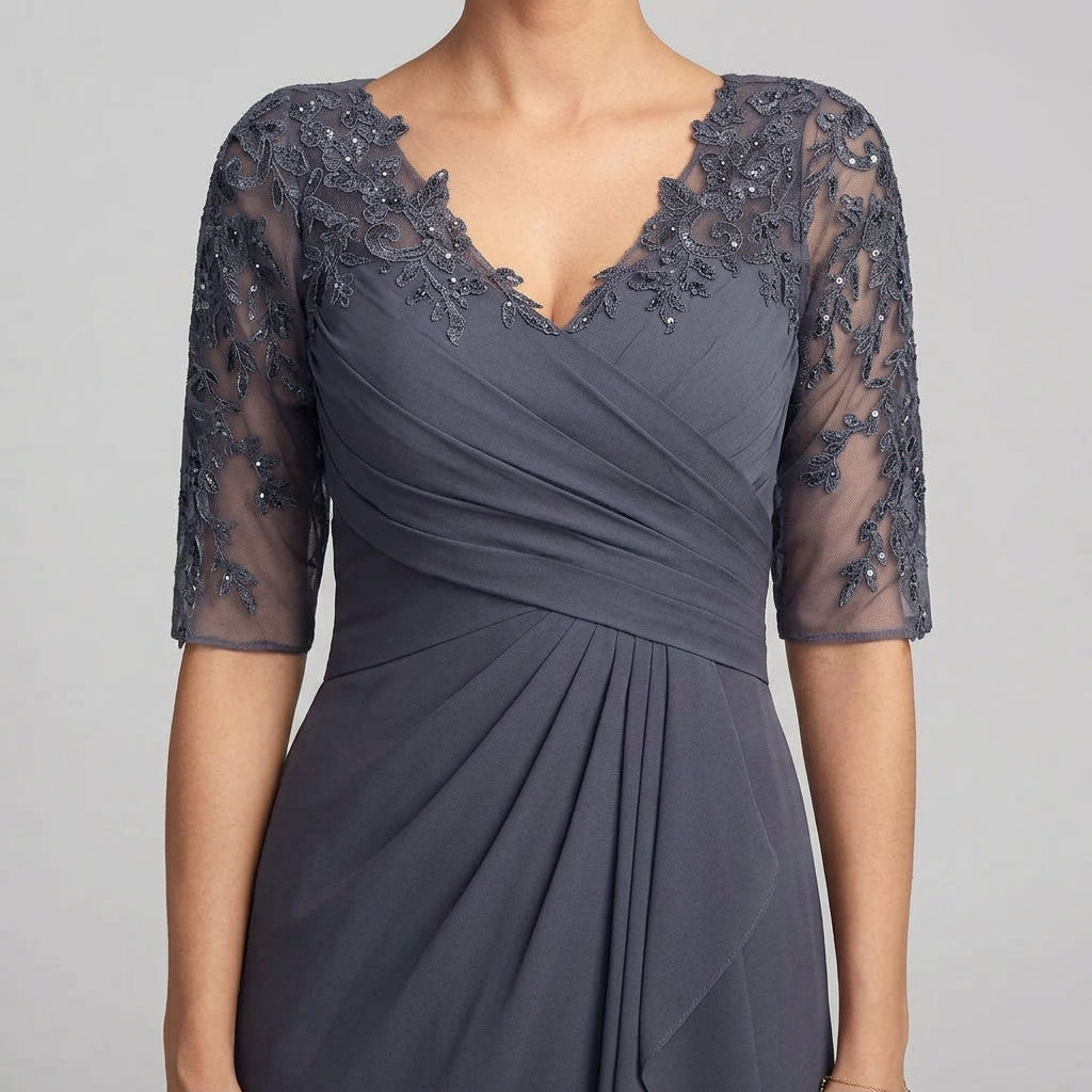 Close-up of dark blue chiffon dress with lace applique V-neck and sheer lace sleeves