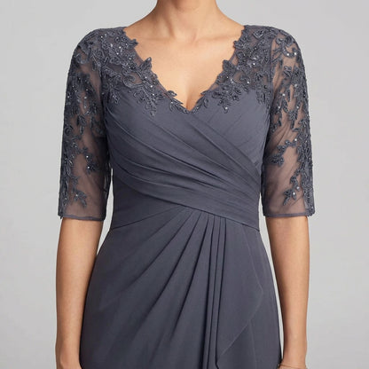 Close-up of dark blue chiffon dress with lace applique V-neck and sheer lace sleeves