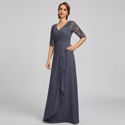 Navy blue chiffon mother-of-the-bride dress with lace sleeves, V-neck, and draped hem