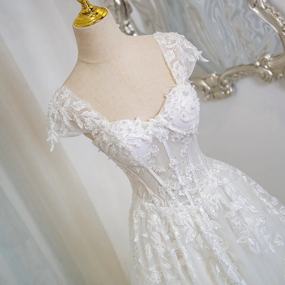 Ivory lace cap-sleeve bodice with scalloped sweetheart neckline and beaded details