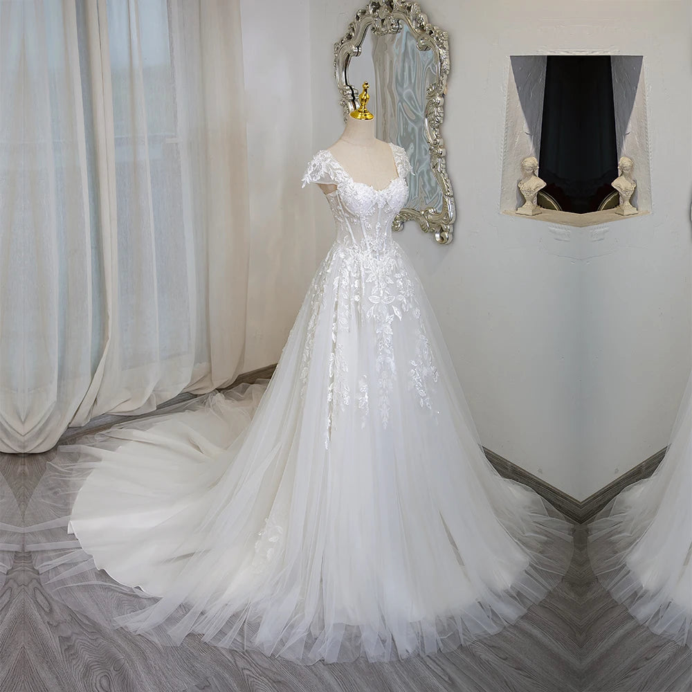 Ivory lace tulle wedding dress with cap sleeves and full flared skirt