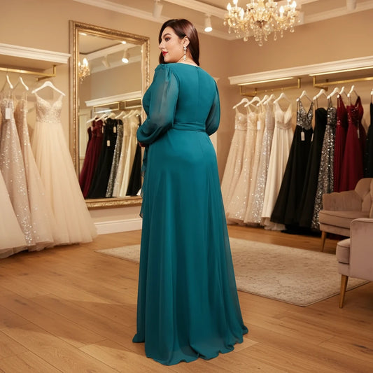 Teal chiffon crossover maxi dress from back, long sleeves, belted waist, flowing skirt