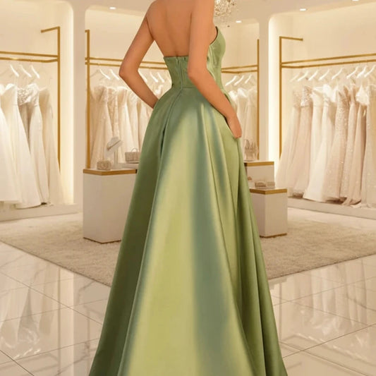 Green strapless satin A-line dress with open back and gathered waist