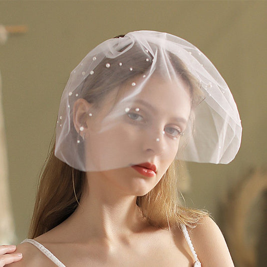 Ivory birdcage veil headpiece with pearl-studded tulle mesh, wide cap style