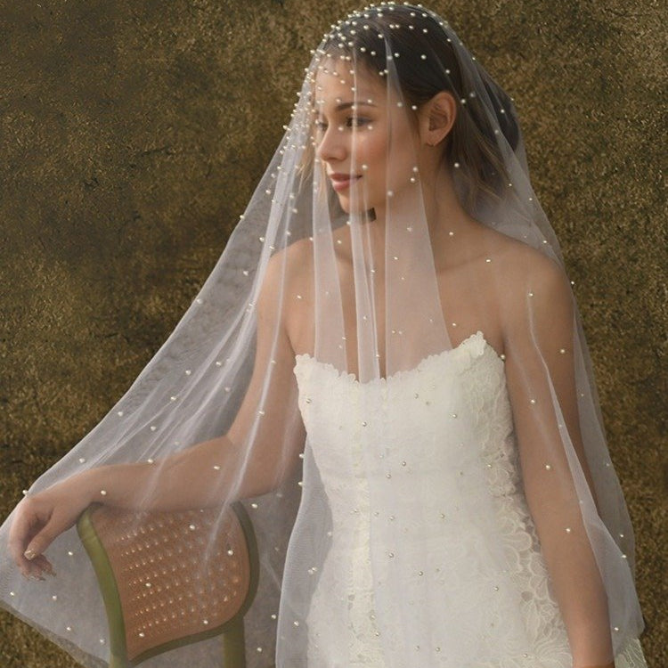 Short wedding veil with pearl-studded netting and scalloped edge