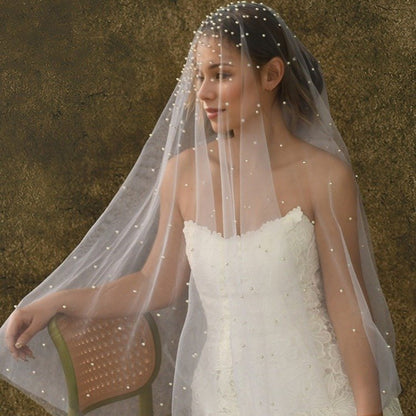 Short wedding veil with pearl-studded netting and scalloped edge