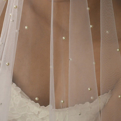 Scalloped hem of sheer veil with small pearl embellishments