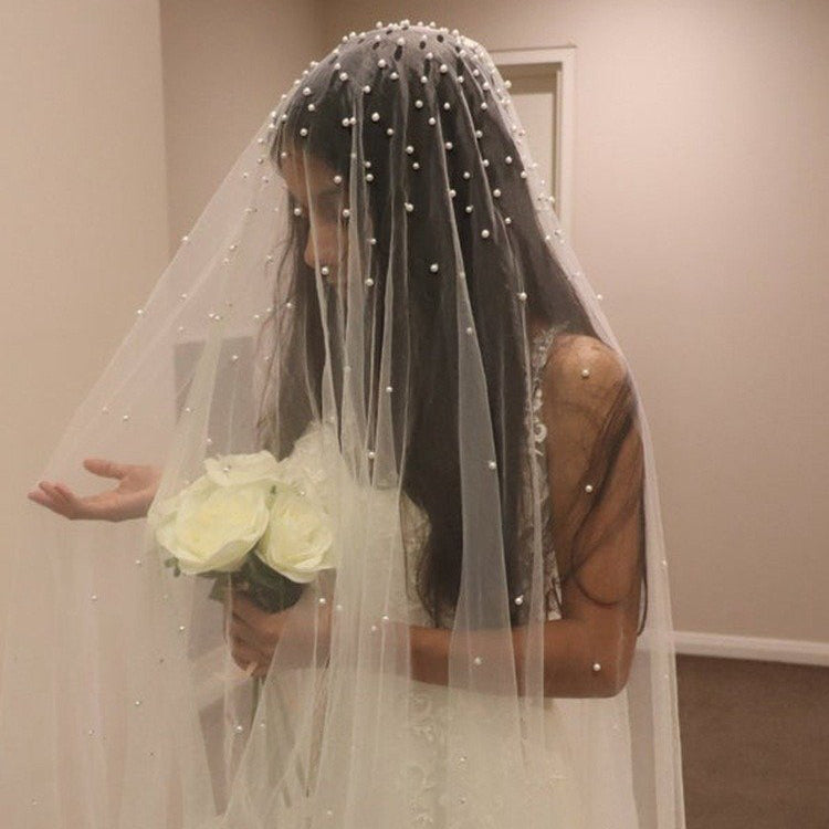 Pearl-dotted sheer veil with rounded beaded headpiece