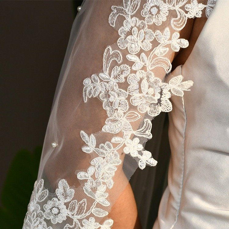 Floral lace appliques on bridal veil edge with small pearl beads