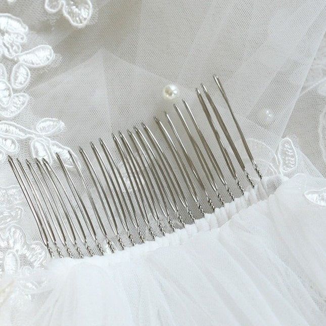 Pearl-tipped comb with tulle and lace trim for bridal veil