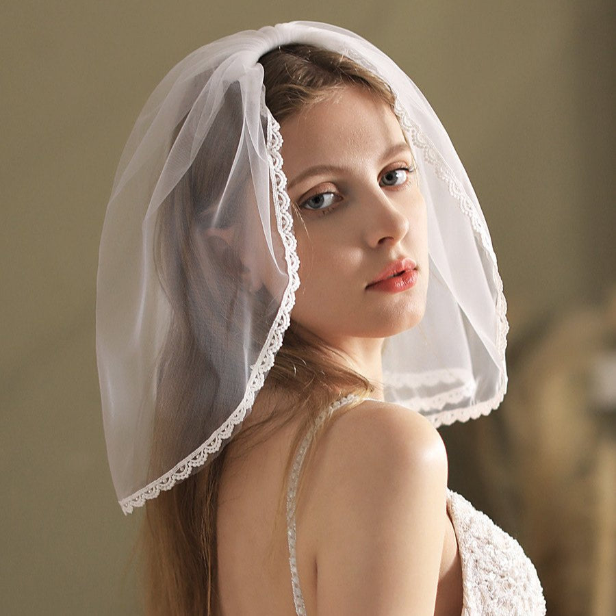 White short bridal veil with lace-trim border, side drape