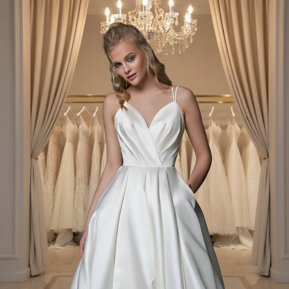 White satin A-line wedding dress with V-neck bodice and spaghetti straps