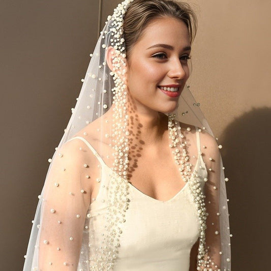 Ivory tulle bridal veil with pearl bead trim along edges and scattered dot detailing