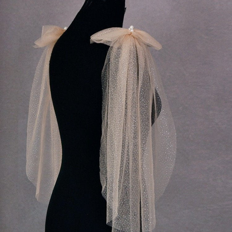 Champagne glitter tulle shoulder drape with pearl cluster on dress form