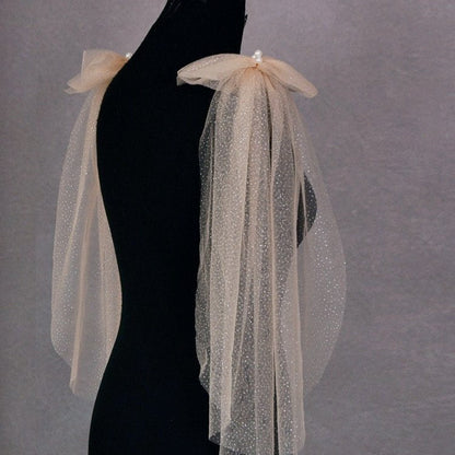 Champagne glitter tulle shoulder drape with pearl cluster on dress form