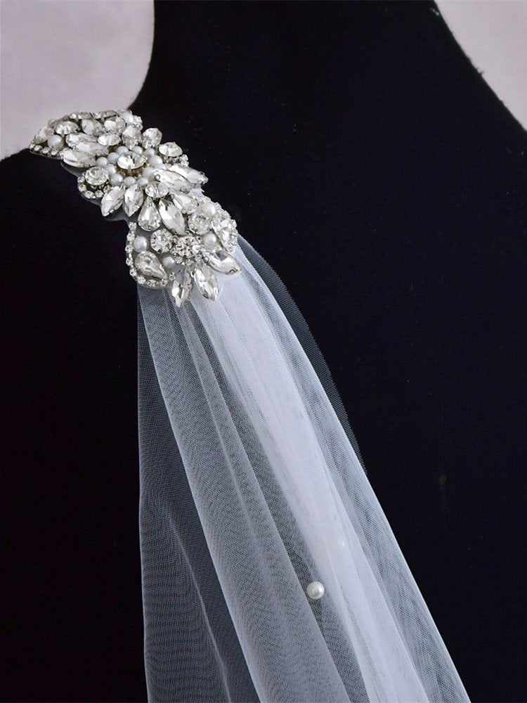 White tulle bridal veil shoulder detail with crystal and pearl applique on strap