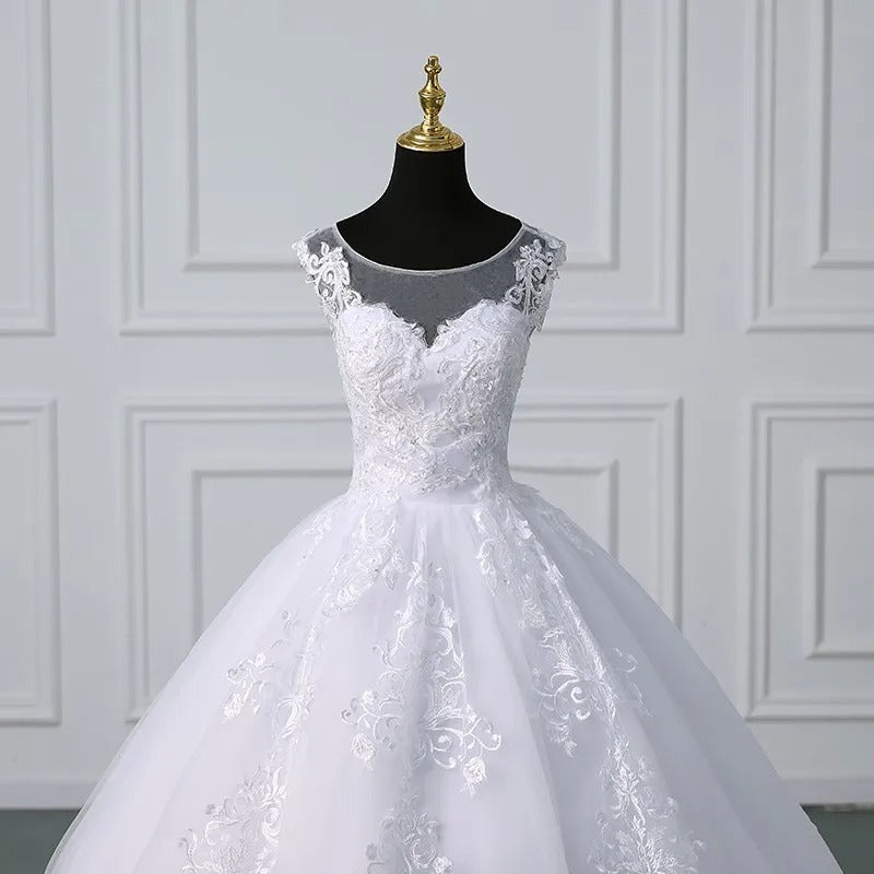 White lace sleeveless ball gown with off-shoulder lace trim and fitted embroidered bodice