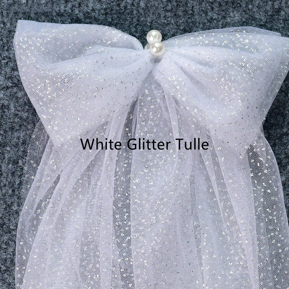 White glitter tulle shoulder bow with sparkling mesh and pearl center