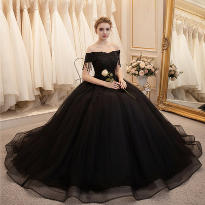 Black off-shoulder ball gown with textured lace bodice and voluminous tulle skirt
