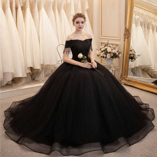 Black off-shoulder ball gown with textured lace bodice and voluminous tulle skirt